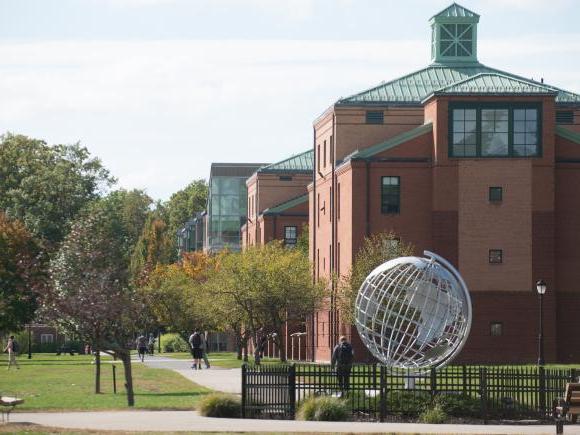 View of the campus green, looking toward Courtney Hall and the globe sculpture