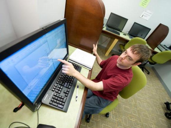 male student using touch screen computer in the Banacos Center